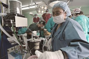 Busy surgical team operating in a hospital theatre, focusing on precision and teamwork.