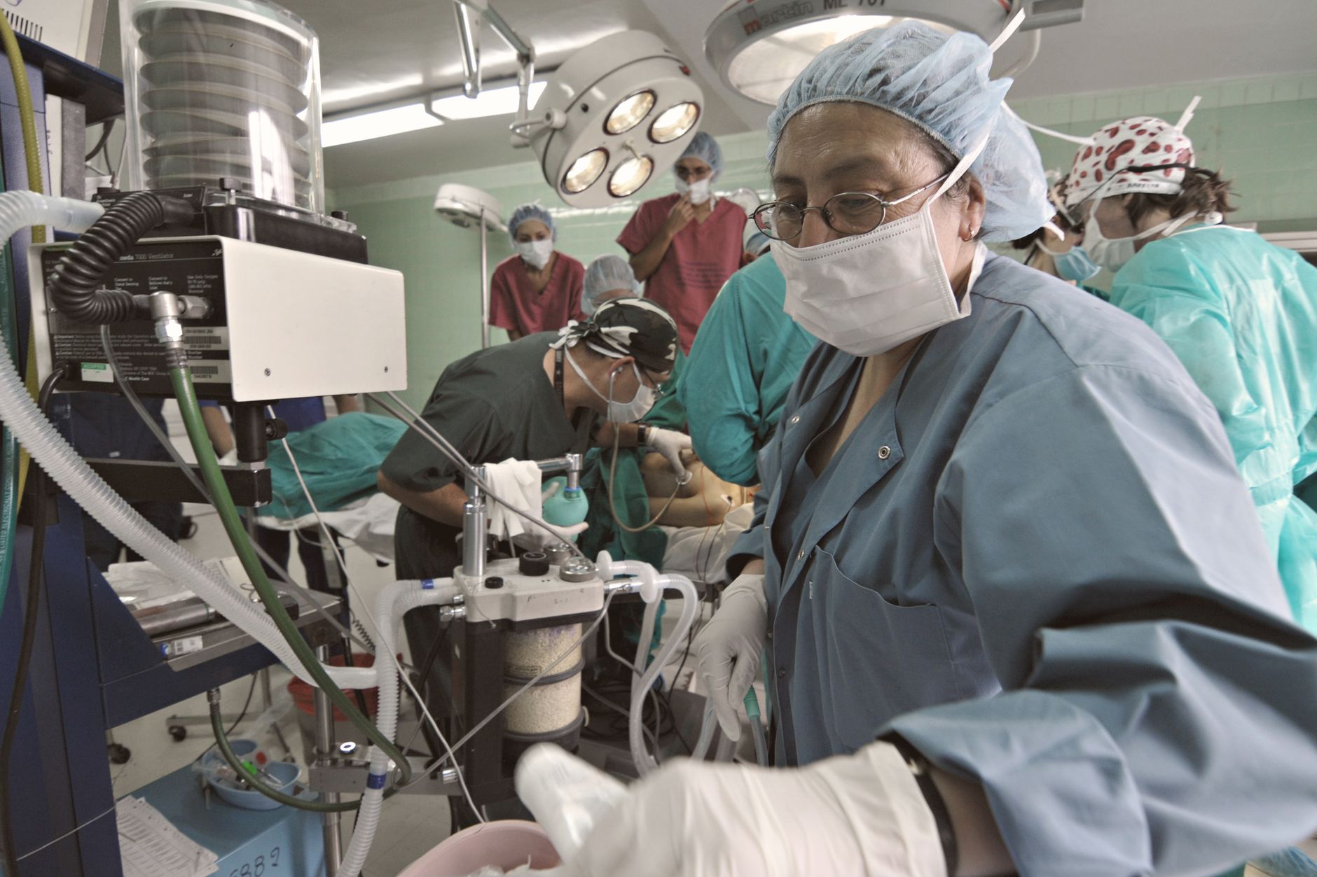 Busy surgical team operating in a hospital theatre, focusing on precision and teamwork.