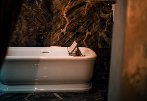 Luxurious bathroom featuring a classic white bathtub against elegant marble walls, creating a serene ambiance.